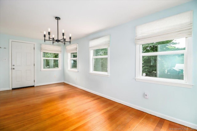 234 Forest Dr, Wethersfield, CT 06109 - unfurnished dining area featuring a chandelier and light wood-style floors