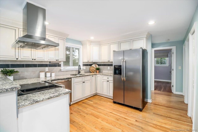 234 Forest Dr, Wethersfield, CT 06109 - kitchen with stainless steel fridge with ice dispenser, wall chimney exhaust hood, tasteful backsplash, white cabinetry, and light stone countertops