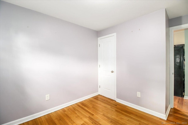 234 Forest Dr, Wethersfield, CT 06109 - unfurnished bedroom featuring light wood-style floors and black fridge