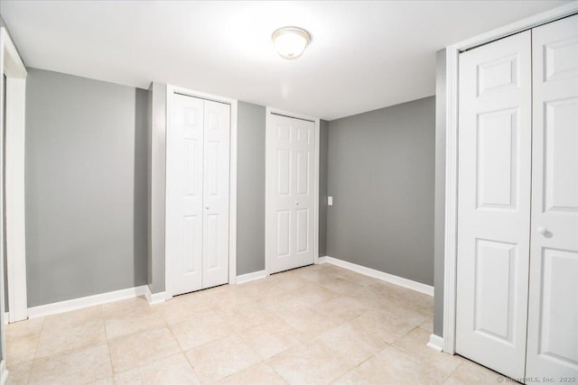 234 Forest Dr, Wethersfield, CT 06109 - unfurnished bedroom with multiple closets and baseboards