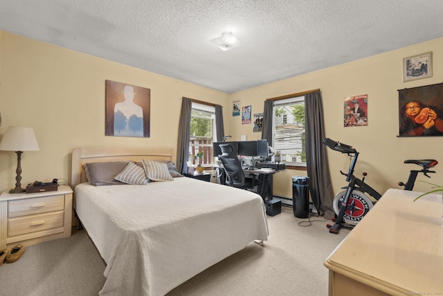 190 Main St, Plainfield, CT 06354 - bedroom with light colored carpet, a desk, a textured ceiling, and baseboard heating