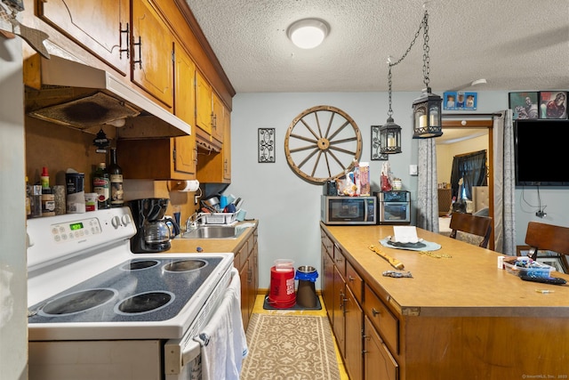 190 Main St, Plainfield, CT 06354 - kitchen featuring white electric stove, stainless steel microwave, under cabinet range hood, brown cabinets, and a textured ceiling