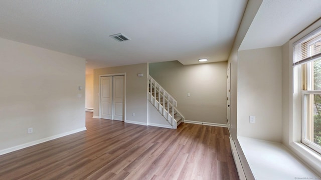 10 Cianci Ave Apt 9, Plainville, CT 06062 - unfurnished room featuring wood finished floors, stairway, and a baseboard radiator