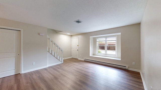 10 Cianci Ave Apt 9, Plainville, CT 06062 - foyer entrance with a baseboard heating unit, stairs, and wood finished floors