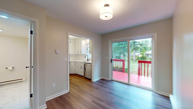 10 Cianci Ave Apt 9, Plainville, CT 06062 - unfurnished dining area with a baseboard radiator and dark wood-style flooring