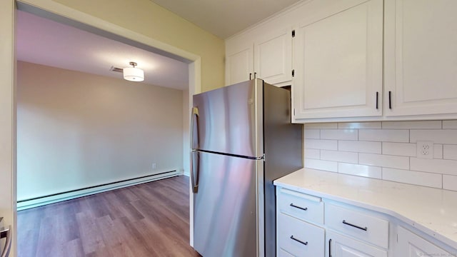 10 Cianci Ave Apt 9, Plainville, CT 06062 - kitchen with freestanding refrigerator, white cabinetry, a baseboard radiator, and backsplash