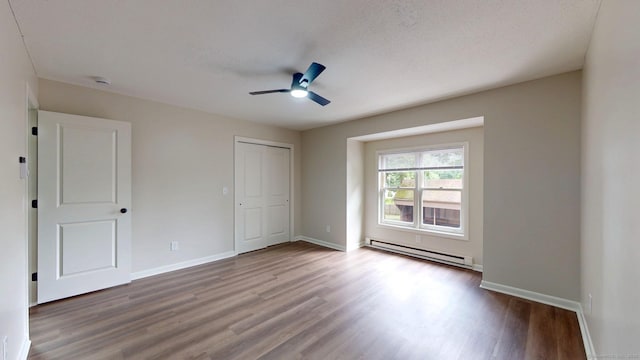 10 Cianci Ave Apt 9, Plainville, CT 06062 - unfurnished bedroom featuring a baseboard heating unit, wood finished floors, a ceiling fan, and a closet