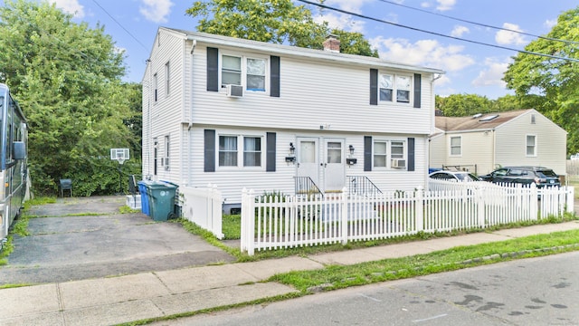 81 W Easton St, Hamden, CT 06514 - colonial-style house with a chimney, a fenced front yard, driveway, and cooling unit