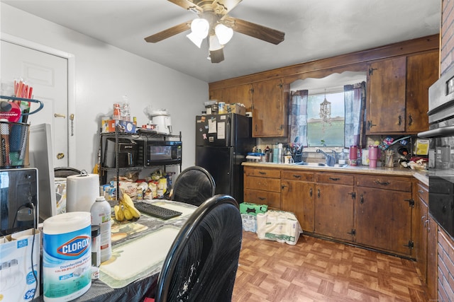 81 W Easton St, Hamden, CT 06514 - kitchen with black appliances, ceiling fan, light countertops, and brown cabinetry