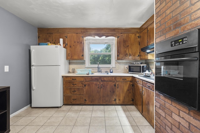 81 W Easton St, Hamden, CT 06514 - kitchen featuring freestanding refrigerator, oven, light countertops, stainless steel microwave, and brown cabinets