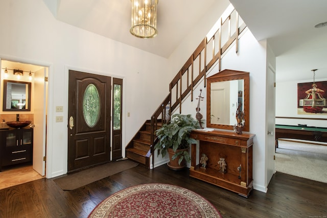 22 Ledgewood Rd, Redding, CT 06896 - foyer featuring wood finished floors, a chandelier, and stairs
