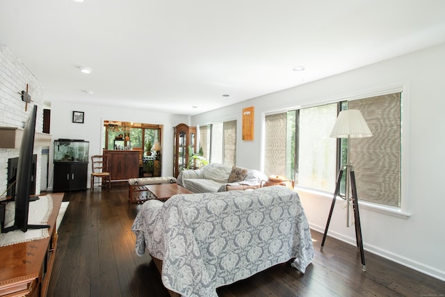 22 Ledgewood Rd, Redding, CT 06896 - living room with healthy amount of natural light, dark wood-type flooring, and a brick fireplace