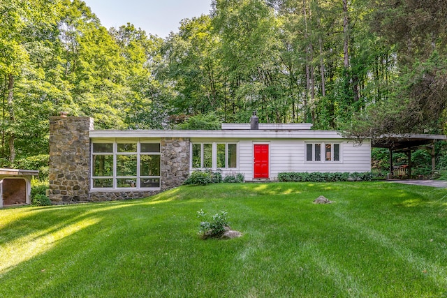 96 Sherman Rd, New Milford, CT 06776 - view of front of house with a chimney, a front lawn, a carport, and stone siding