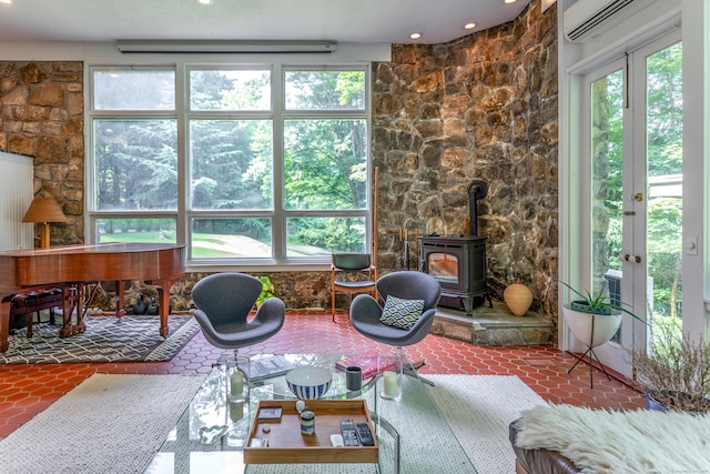 96 Sherman Rd, New Milford, CT 06776 - sunroom with french doors, a wood stove, a wall unit AC, and plenty of natural light