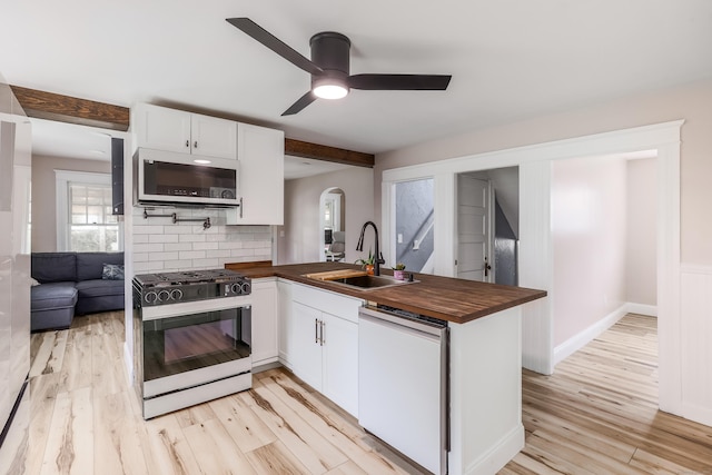 36 School St, Killingly, CT 06239 - kitchen featuring white appliances, wooden counters, a peninsula, light wood-type flooring, and tasteful backsplash