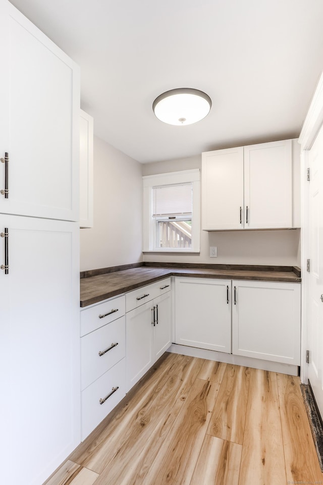 36 School St, Killingly, CT 06239 - kitchen with light wood-style floors, white cabinetry, and wood counters