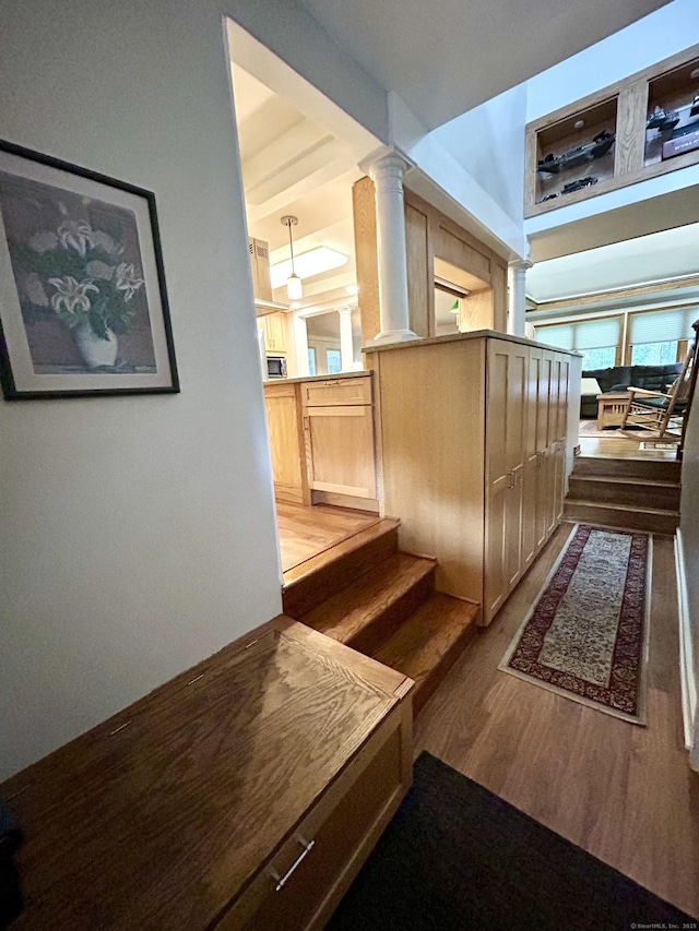 38 Tanglewood Rd, Farmington, CT 06032 - hall featuring dark wood-style floors, ornate columns, and stairs