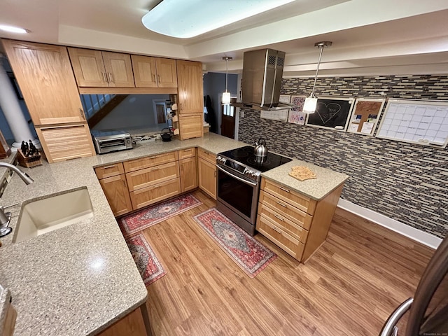 38 Tanglewood Rd, Farmington, CT 06032 - kitchen with stainless steel electric stove, island range hood, a peninsula, light wood-style flooring, and pendant lighting