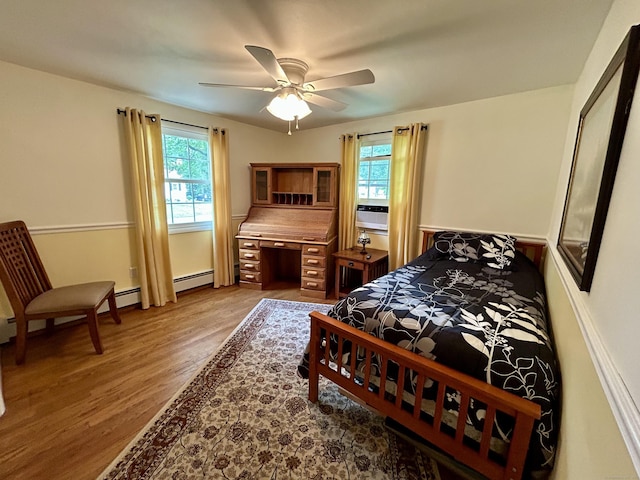 38 Tanglewood Rd, Farmington, CT 06032 - bedroom featuring multiple windows, wood finished floors, a baseboard radiator, and a ceiling fan