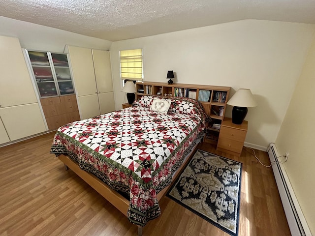 38 Tanglewood Rd, Farmington, CT 06032 - bedroom featuring a baseboard radiator, wood finished floors, and a textured ceiling