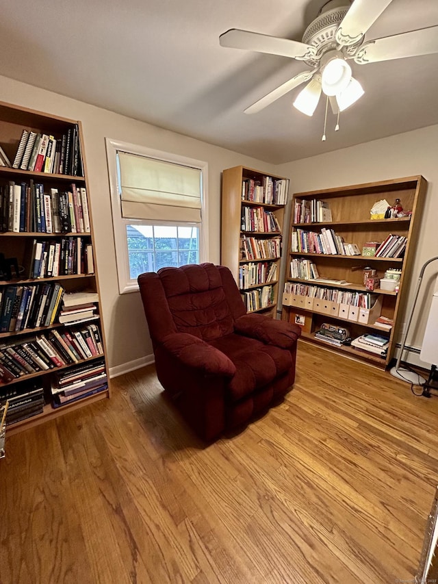 38 Tanglewood Rd, Farmington, CT 06032 - sitting room with ceiling fan, wood finished floors, and wall of books