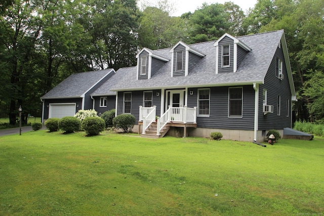 46 Ryan Rd, Tolland, CT 06084 - new england style home featuring a front lawn, a shingled roof, an attached garage, cooling unit, and view of wooded area