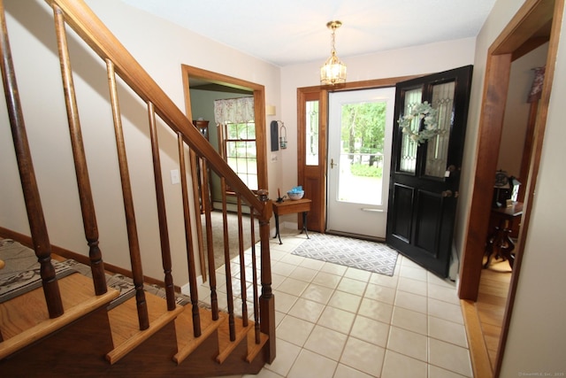 46 Ryan Rd, Tolland, CT 06084 - foyer featuring stairway, baseboard heating, light tile patterned floors, and a chandelier