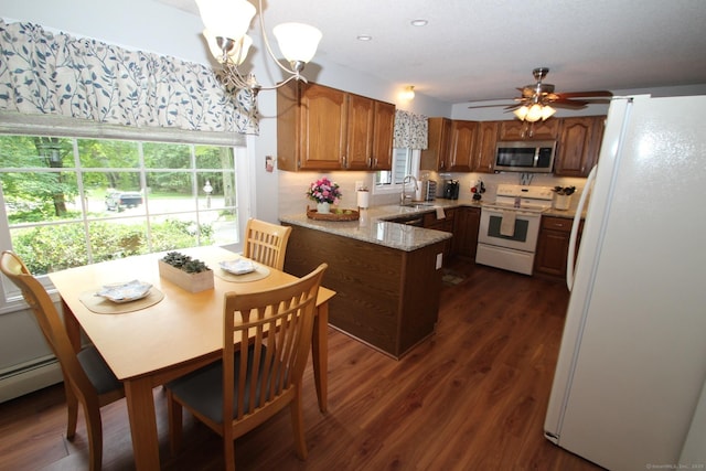 46 Ryan Rd, Tolland, CT 06084 - kitchen with white appliances, a peninsula, healthy amount of natural light, and dark wood finished floors