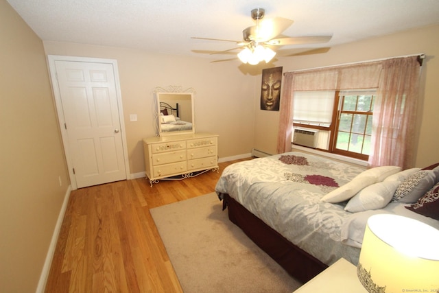 46 Ryan Rd, Tolland, CT 06084 - bedroom with light wood-style flooring, cooling unit, baseboard heating, and a ceiling fan