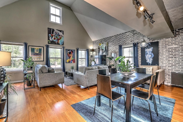 685 Quinnipiac Ave Unit 685, New Haven, CT 06513 - dining space featuring brick wall, high vaulted ceiling, wood finished floors, and track lighting