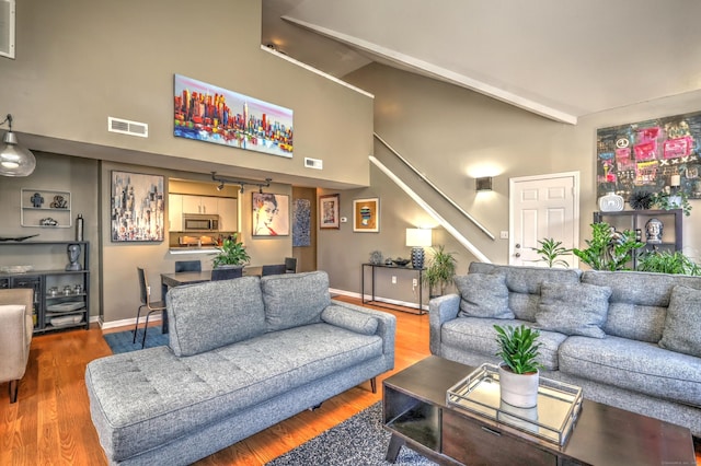 685 Quinnipiac Ave Unit 685, New Haven, CT 06513 - living room featuring wood finished floors, stairs, and high vaulted ceiling
