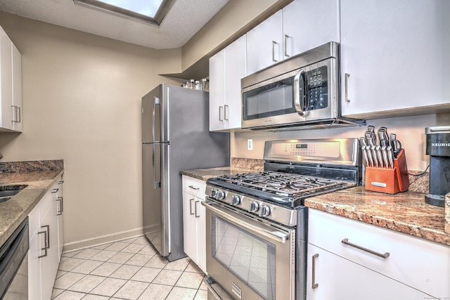 685 Quinnipiac Ave Unit 685, New Haven, CT 06513 - kitchen featuring stainless steel appliances, white cabinetry, light tile patterned floors, and stone counters