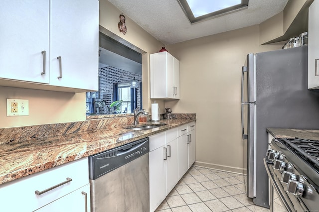 685 Quinnipiac Ave Unit 685, New Haven, CT 06513 - kitchen with appliances with stainless steel finishes, white cabinets, light tile patterned floors, a textured ceiling, and stone counters