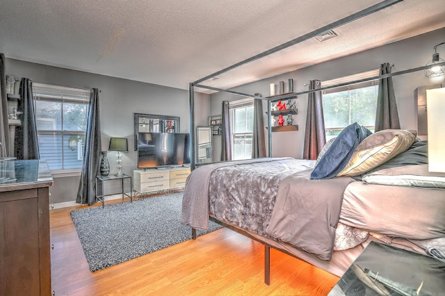 685 Quinnipiac Ave Unit 685, New Haven, CT 06513 - bedroom featuring wood finished floors, multiple windows, and a textured ceiling