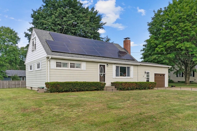 24 Claudia Ave, Brooklyn, CT 06234 - view of front facade featuring a chimney, solar panels, an attached garage, and a shingled roof