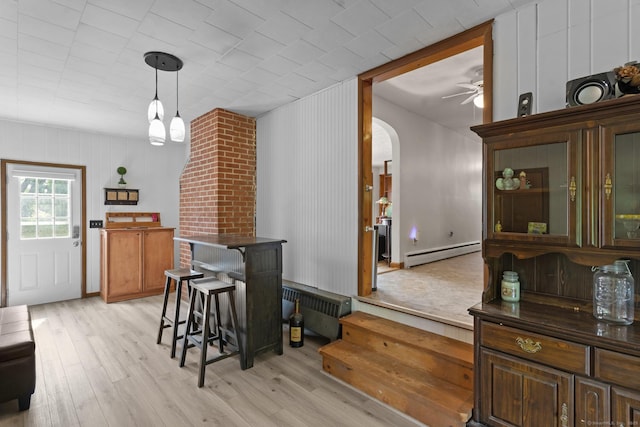 24 Claudia Ave, Brooklyn, CT 06234 - dining space with a baseboard radiator, arched walkways, light wood-style flooring, and ceiling fan