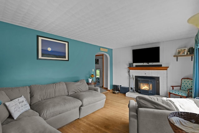 24 Claudia Ave, Brooklyn, CT 06234 - living area with arched walkways, wood finished floors, and a brick fireplace