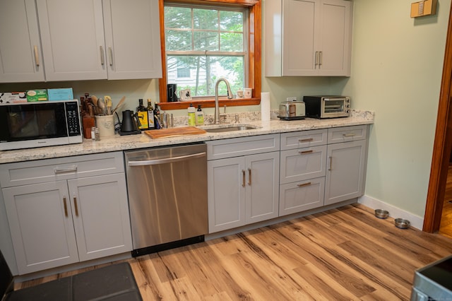 65 Willard St, Hamden, CT 06518 - kitchen with stainless steel dishwasher, gray cabinetry, light wood-type flooring, and light stone countertops