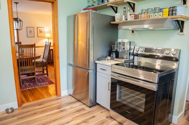 65 Willard St, Hamden, CT 06518 - kitchen featuring appliances with stainless steel finishes, ventilation hood, light wood-style flooring, and white cabinets