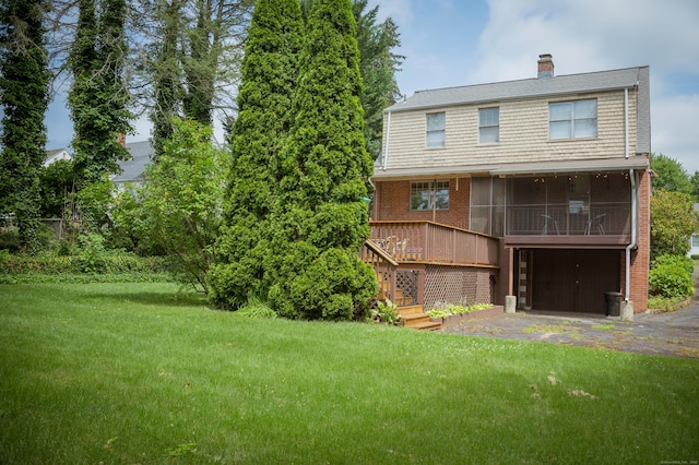 65 Willard St, Hamden, CT 06518 - back of house featuring a yard, driveway, a garage, a chimney, and a sunroom