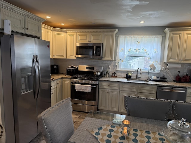 15 Edwards St, Bridgeport, CT 06606 - kitchen featuring stainless steel appliances, backsplash, light stone countertops, and recessed lighting