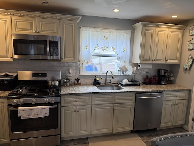 15 Edwards St, Bridgeport, CT 06606 - kitchen with appliances with stainless steel finishes, tasteful backsplash, light stone counters, light tile patterned floors, and recessed lighting
