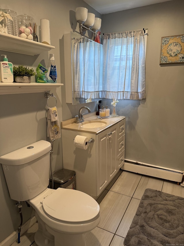 15 Edwards St, Bridgeport, CT 06606 - half bath with baseboard heating, vanity, and tile patterned flooring