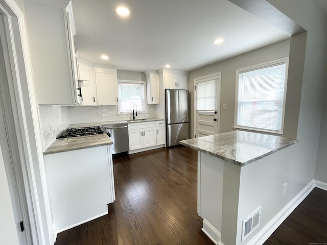 63 Barraclough Ave, Hamden, CT 06517 - kitchen with appliances with stainless steel finishes, dark wood finished floors, white cabinets, backsplash, and recessed lighting