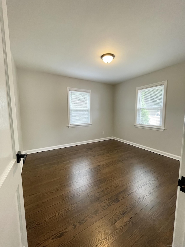 63 Barraclough Ave, Hamden, CT 06517 - empty room featuring dark wood-style floors and healthy amount of natural light