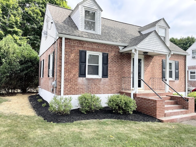 63 Barraclough Ave, Hamden, CT 06517 - cape cod home featuring brick siding, a front yard, and roof with shingles