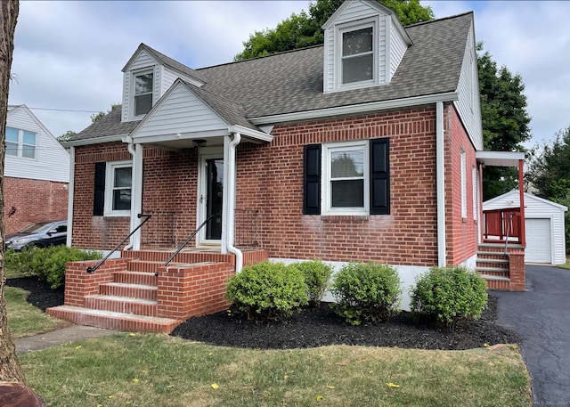 63 Barraclough Ave, Hamden, CT 06517 - cape cod house with brick siding, an outbuilding, roof with shingles, and a detached garage
