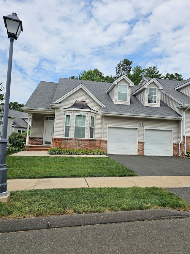 6 Haskins Rd Unit 6, Windsor, CT 06095 - view of front of home with brick siding, a garage, driveway, and a front yard
