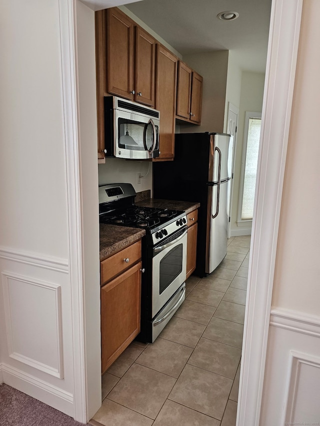 6 Haskins Rd Unit 6, Windsor, CT 06095 - kitchen with stainless steel appliances, dark countertops, brown cabinets, and light tile patterned flooring