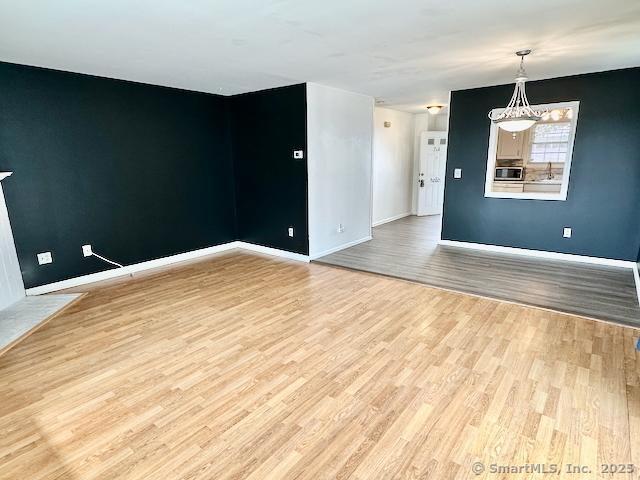 2390 State St Apt 7J, Hamden, CT 06517 - unfurnished room with light wood finished floors and baseboards